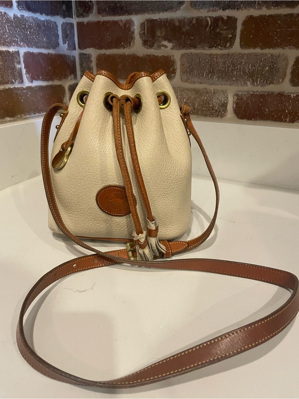 Vintage Dooney & Bourke Cream and Brown Pebbled Leather Drawstring Crossbody